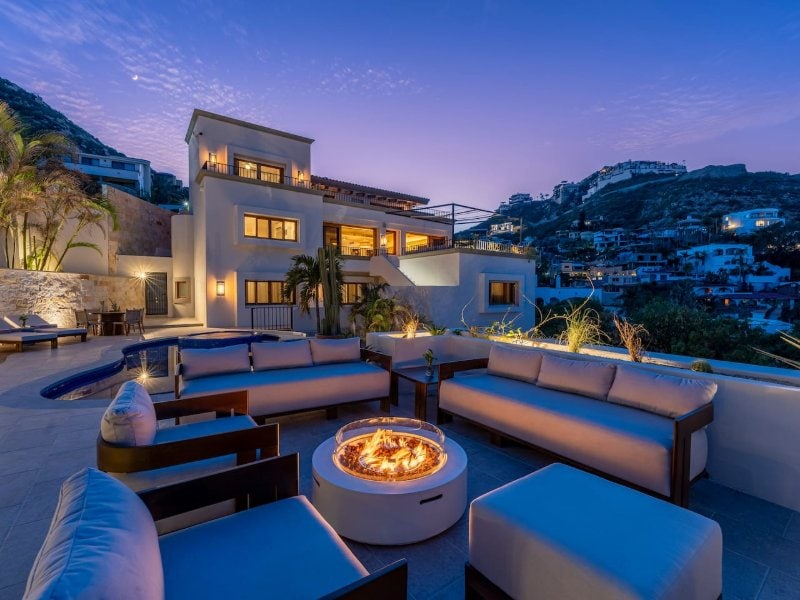 Rooftop lounge with a fire pit at dusk at Casa La Piñata in Pedregal, Cabo San Lucas
