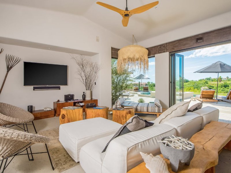 Living room opening onto the pool terrace at Casa Naah Payil in Cabo del Sol, Cabo San Lucas