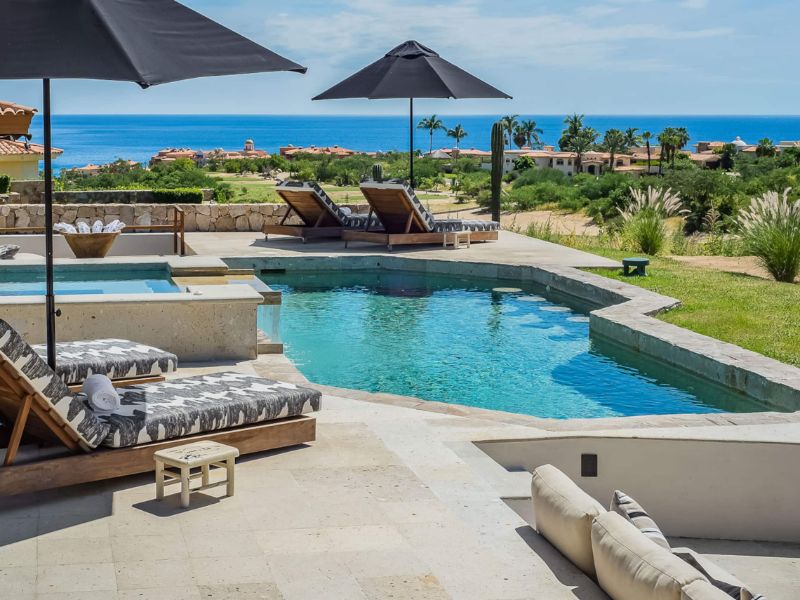 Pool and lounge chairs with Sea of Cortez views at Casa Naah Payil in Cabo del Sol