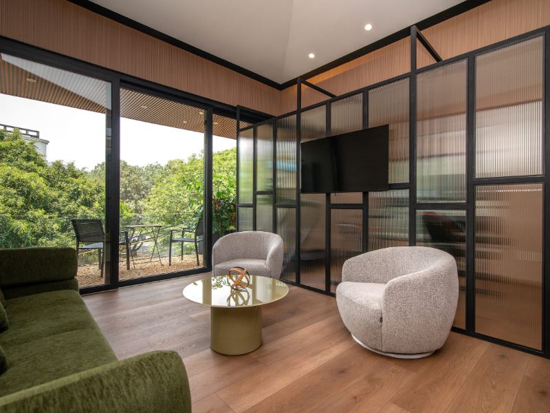 Glass-walled sitting room facing the garden at the Casa Nogal Garden Suite Airbnb in Polanco, Mexico City