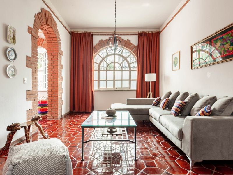 Living room with arched windows at the Colonial House with a Garden, a Coyoacán Airbnb in Mexico City