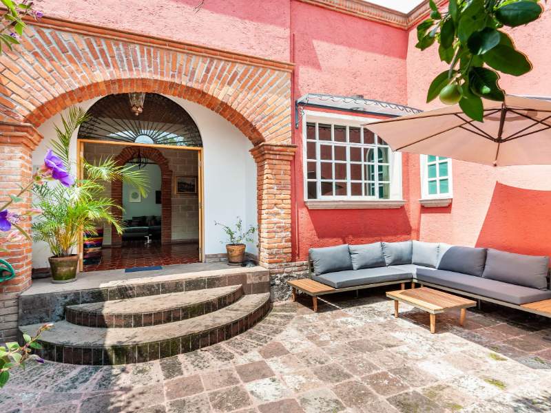 Brick courtyard and garden at the colonial house Airbnb in Coyoacán, Mexico City