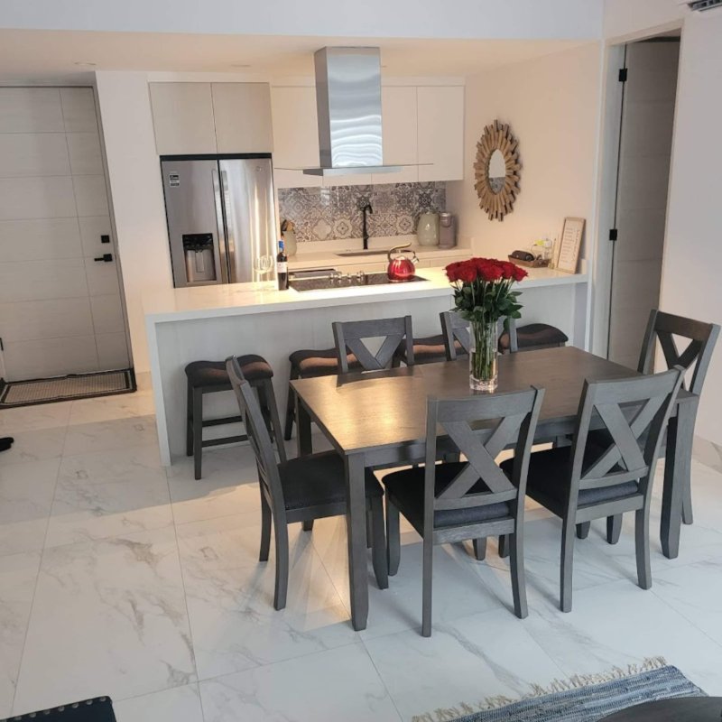 White kitchen and dining table at Condo Azul near Médano Beach in El Tezal, Cabo San Lucas