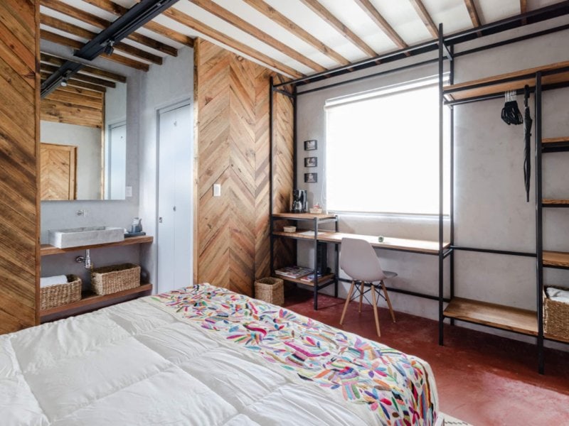 Bedroom with big windows at the Eco Rooftop Loft, a Coyoacan Airbnb in Mexico City