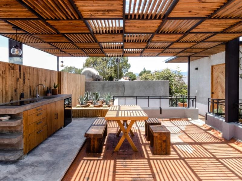 Covered terrace with a dining table at the Eco Rooftop Loft Airbnb in Coyoacán, Mexico City