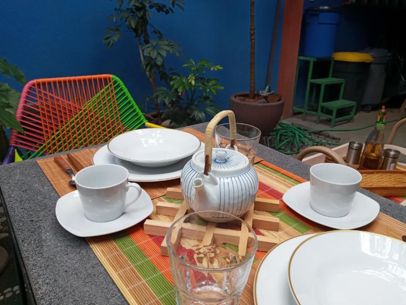 Breakfast table set with a teapot on the patio-garden of the Garden Suite in San Miguel Chapultepec, Mexico City