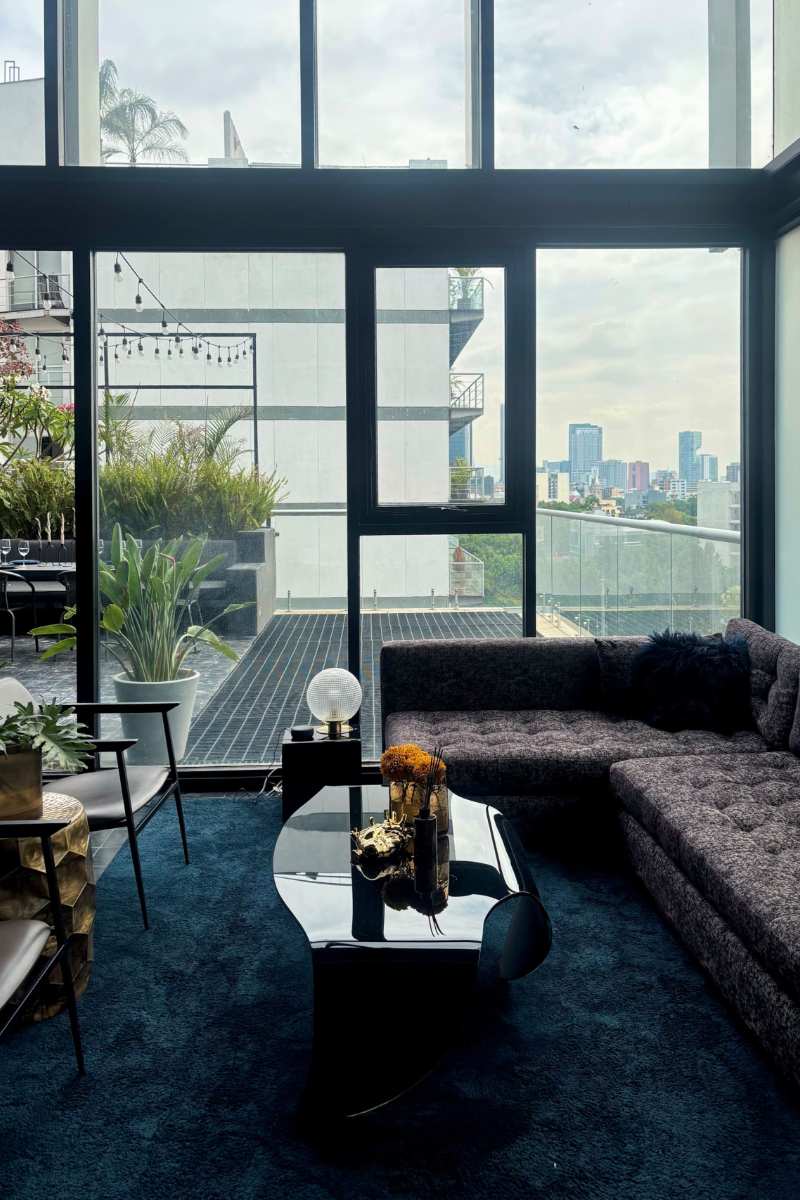 Dark living room with city views at the Lavish in Black Airbnb in Condesa, Mexico City