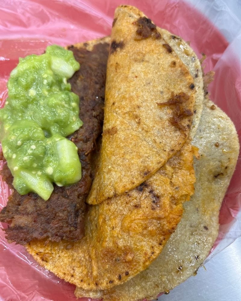 plate of tacos de canasta with green salsa at Los Especiales in Mexico City