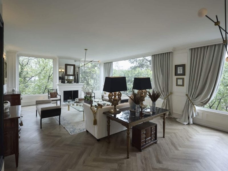 Living room with a fireplace and garden views at the Luxury Villa in Lomas Altas, a luxury Airbnb in Mexico City