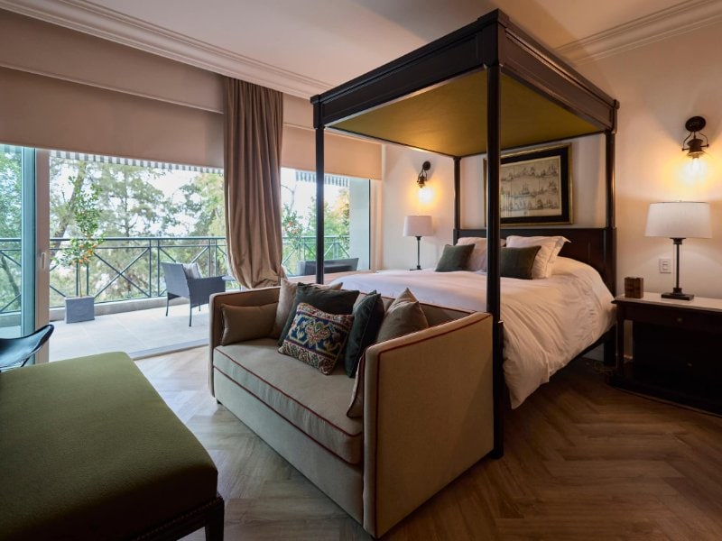 Canopy bed and sofa facing forest views at the Luxury Villa in Lomas Altas with a Chef and Chauffeur, Mexico City