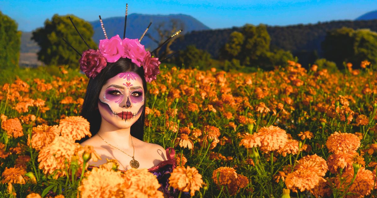 woman in marigold field for the "Why are Marigolds Used for Day of the Dead Flowers?" article