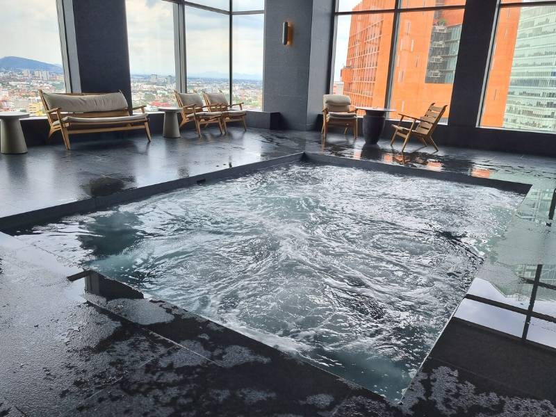 Indoor pool with skyline views at Be Grand Reforma, a Mexico City Airbnb in Juárez