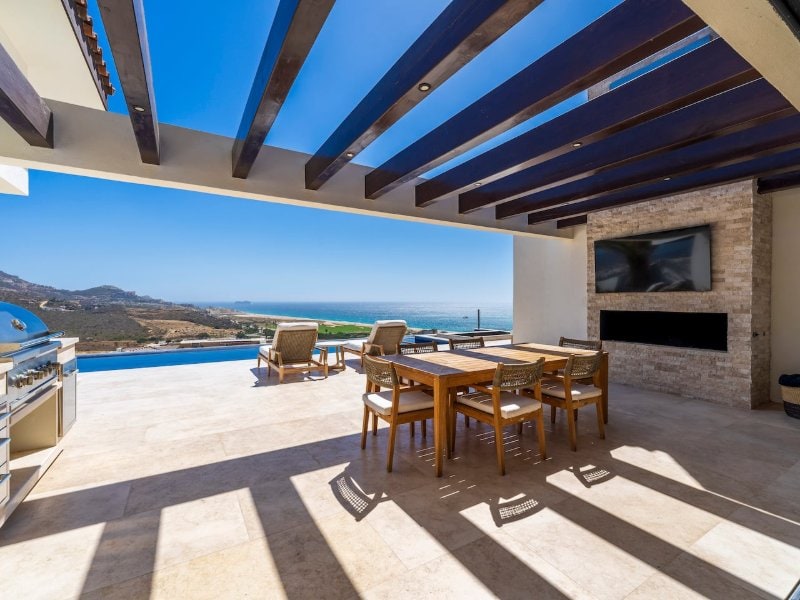 Covered outdoor dining terrace with a grill and ocean views at the Ocean-View Villa in Quivira, Cabo San Lucas