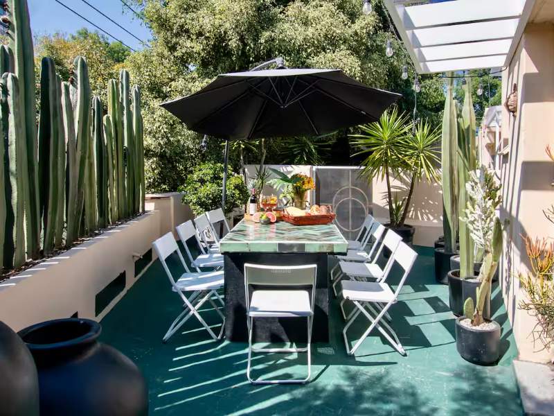 Private rooftop with cacti and a dining table at A Piece of Paradise in Condesa, a Mexico City Airbnb