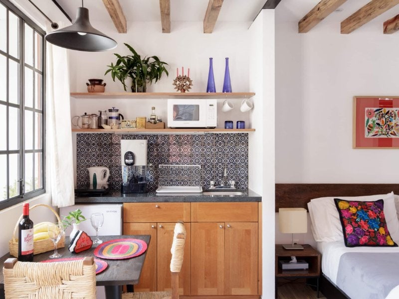Kitchen and sitting area at Posada Coyote, a sunny loft Airbnb in Coyoacán, Mexico City