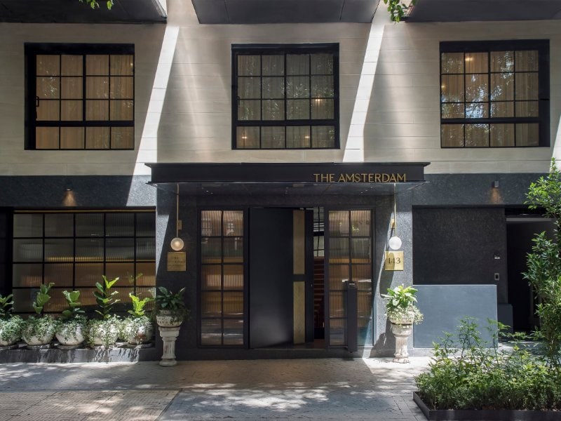Black facade and entrance of The Amsterdam building, home of the Presidential Terrace Suite in Condesa, Mexico City