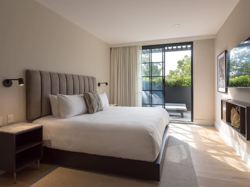 Bedroom with a king bed and a glass door to the terrace in the Presidential Terrace Suite at The Amsterdam, Condesa, Mexico City