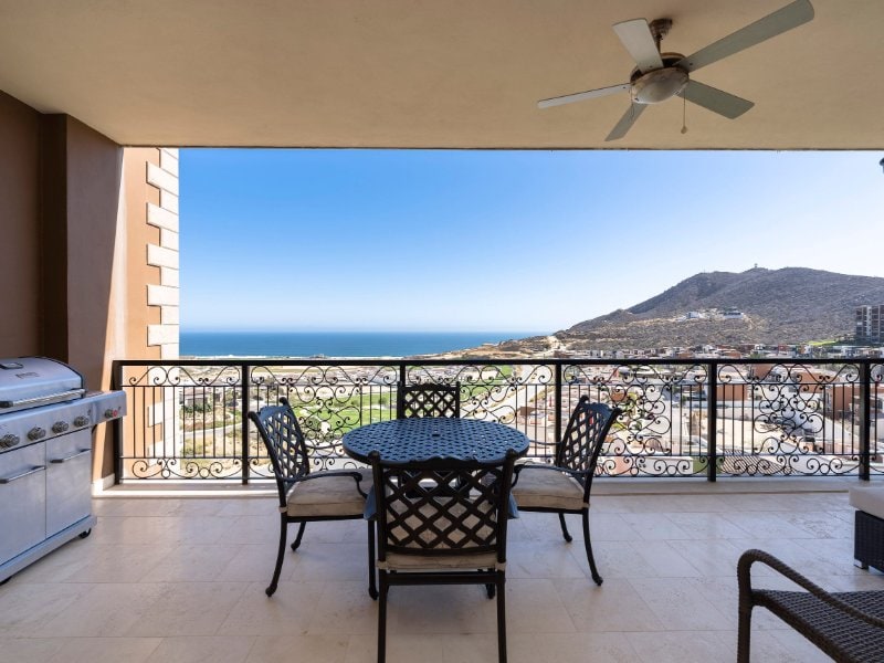 Covered terrace with a grill, dining table and Pacific views at Reel Paradise in Quivira, Cabo San Lucas