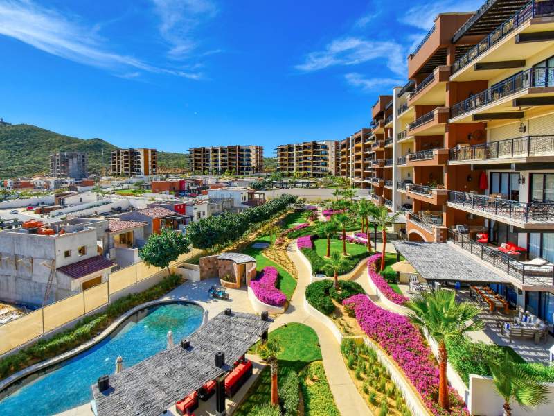 Ocean-view terrace overlooking Copala's pools and gardens at Reel Paradise in Quivira, a Cabo Airbnb