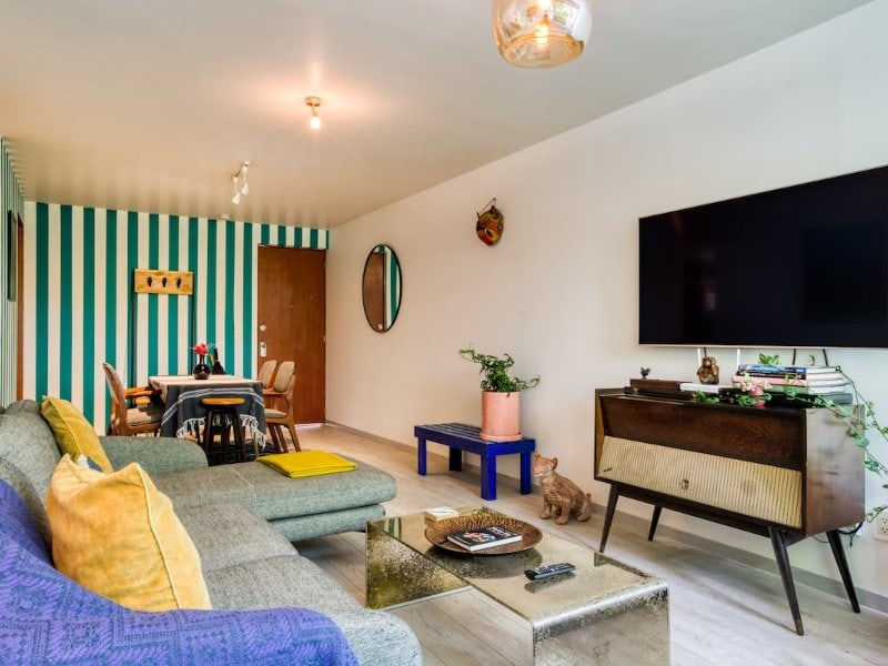 Colorful living room at the Roma Norte 3-bedroom Airbnb with a private patio, Mexico City