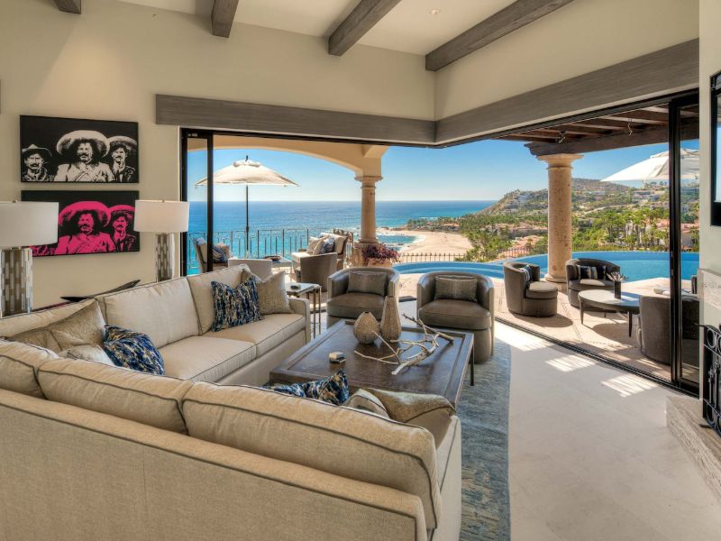 Living room opening onto a pool terrace with ocean views at Seaside La Casita in Palmilla, Cabo Corridor