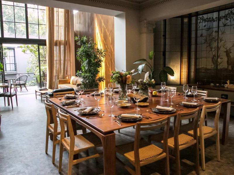 Long dining table set for a dinner party in the 1910 Serviced 4-Bedroom Designer Mansion in Condesa, Mexico City