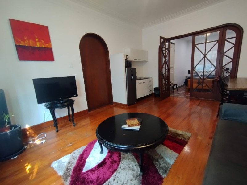 Living room with wood floors and an arched doorway at the Suite with Free Breakfast by Camino Real in Anzures, Mexico City