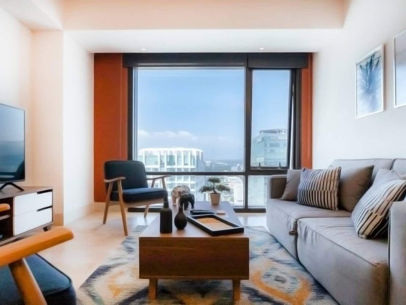 Top-floor living room with big windows at the apartment Airbnb with a home office in Polanco, Mexico City