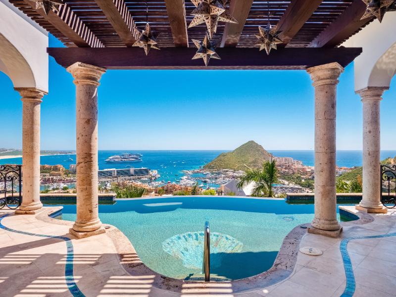Arched terrace with an infinity pool and bay views at Villa Blanca in Pedregal, Cabo San Lucas