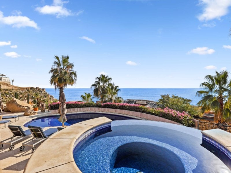 Infinity hot tub and lagoon pool with Pacific views at Villa Isla in Pedregal, Cabo San Lucas