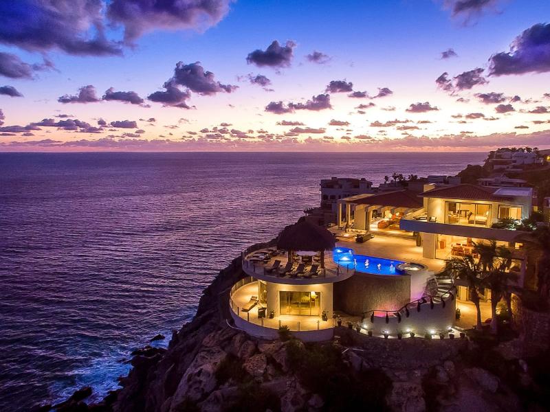 Villa Penasco lit up at sunset on the cliffs of Pedregal, Cabo San Lucas