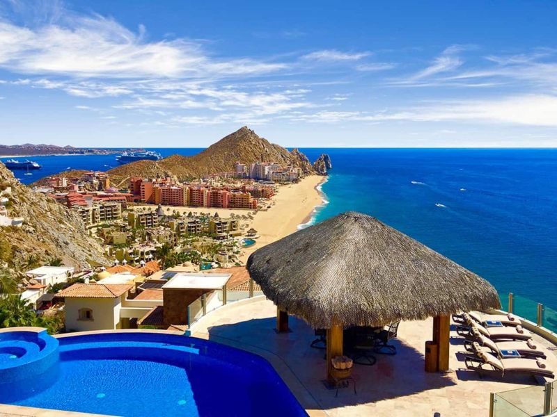 Infinity pool and palapa overlooking Médano Beach at Villa Penasco in Pedregal, Cabo San Lucas