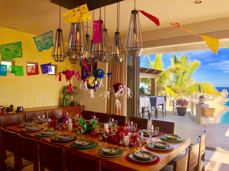 Dining room decorated with papel picado at Villa Penasco in Pedregal, Cabo San Lucas